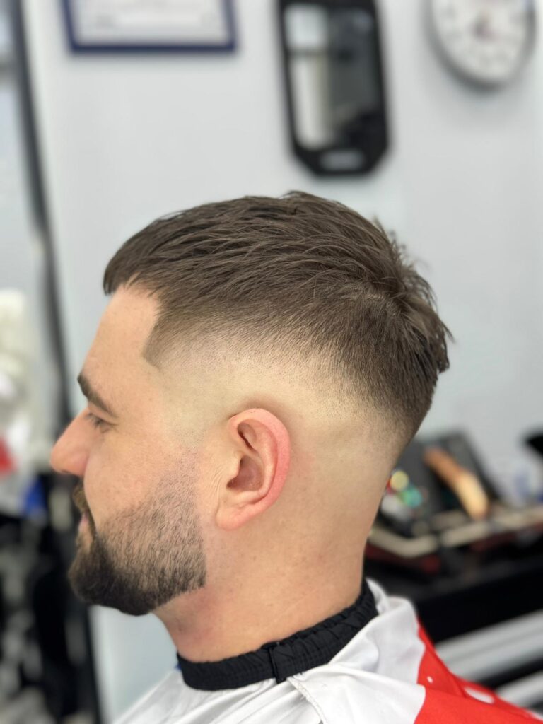 Skin fade with a short textured top and beard