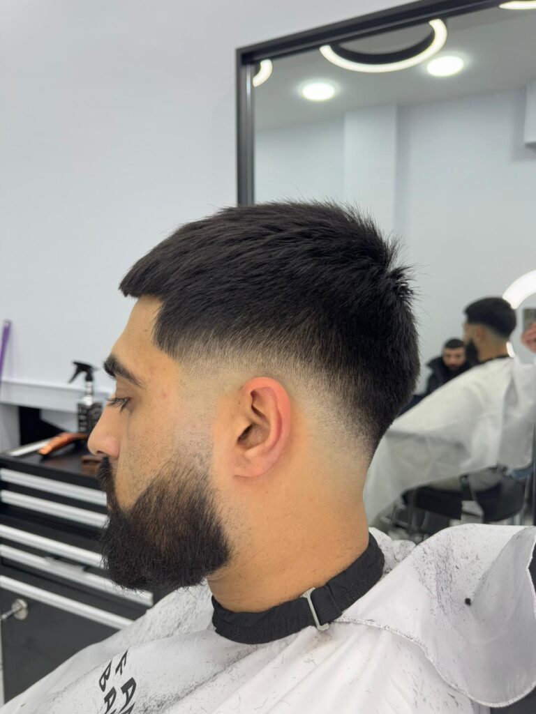 Mid fade with a textured crop and beard